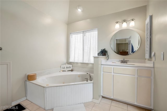 bathroom with tile patterned floors, vanity, a bathing tub, and vaulted ceiling