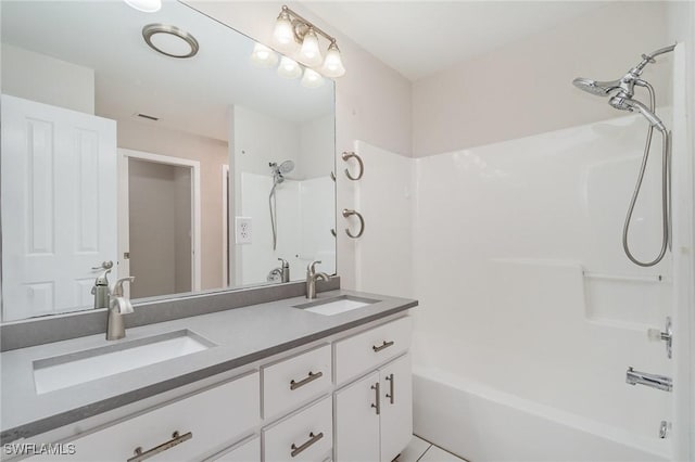 bathroom featuring washtub / shower combination and vanity