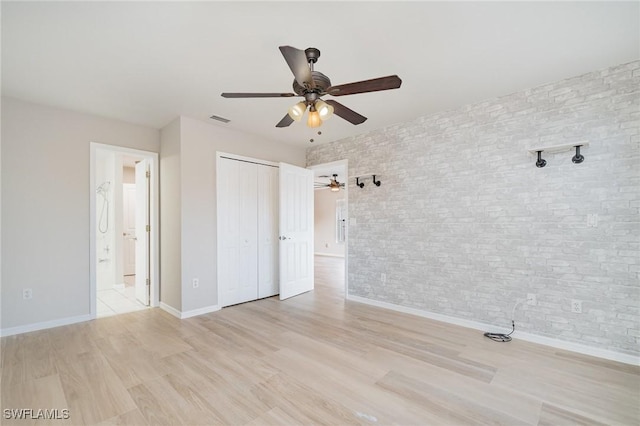 unfurnished bedroom featuring ceiling fan, light wood-type flooring, and a closet