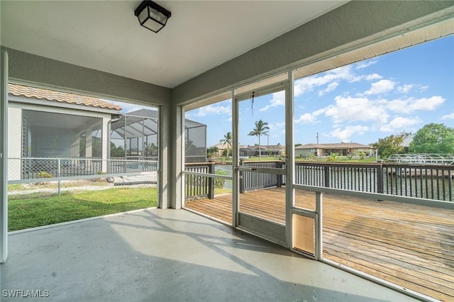 unfurnished sunroom with a water view