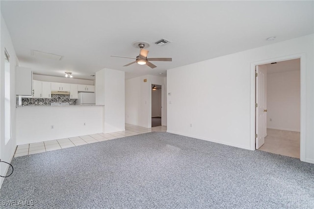 unfurnished living room featuring ceiling fan and light colored carpet