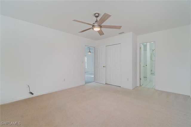 interior space featuring ceiling fan and light carpet