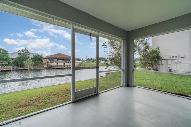 unfurnished sunroom featuring a water view