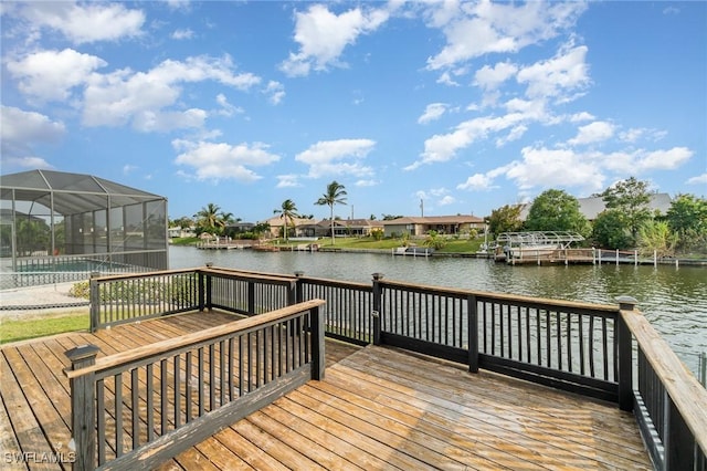 dock area with glass enclosure and a swimming pool side deck with water view