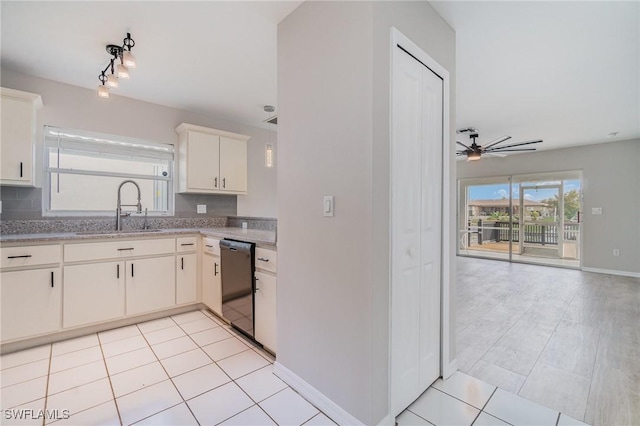 kitchen featuring stainless steel dishwasher, ceiling fan, sink, light tile patterned floors, and white cabinets