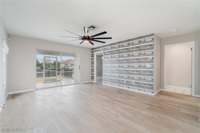 spare room with light wood-type flooring and ceiling fan