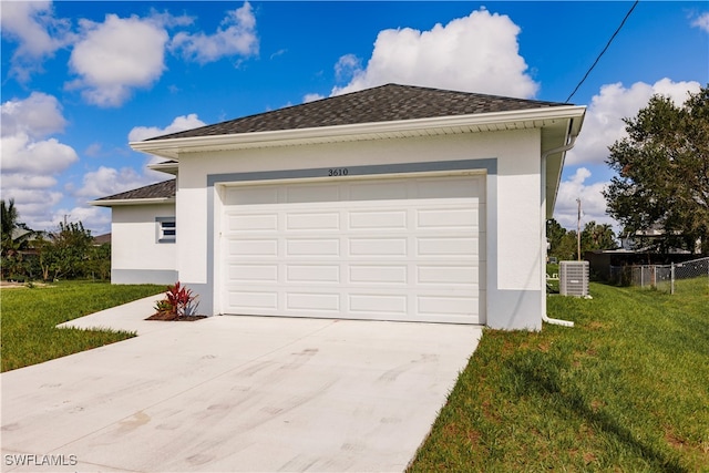 garage featuring a yard and central air condition unit