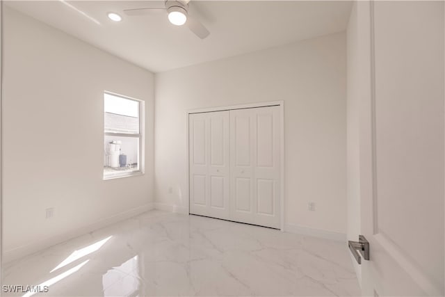 unfurnished bedroom featuring a closet and ceiling fan