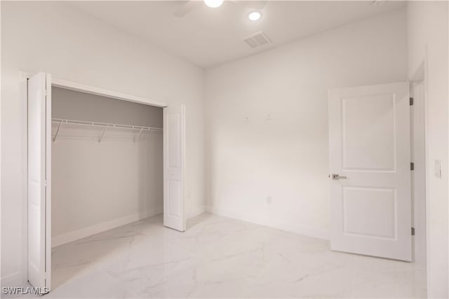 unfurnished bedroom with a closet and ceiling fan