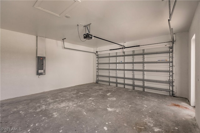 garage with a garage door opener and electric panel