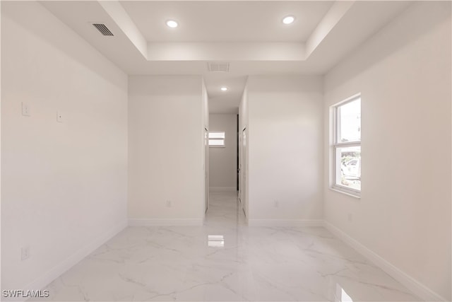 spare room featuring a tray ceiling