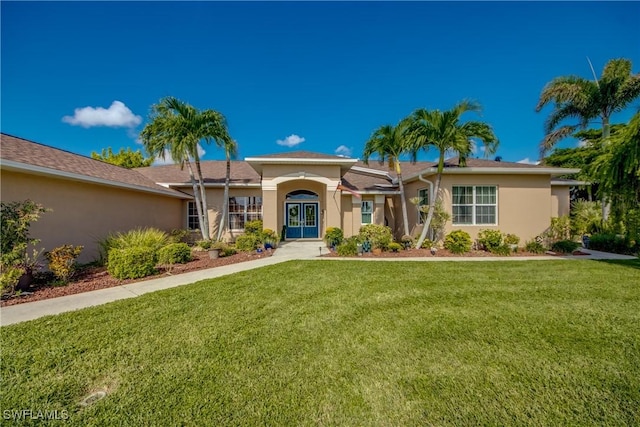 view of front of house with stucco siding and a front lawn