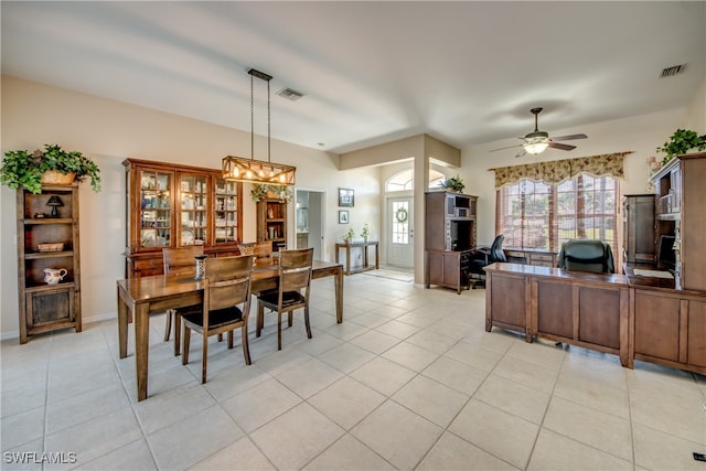 dining room with light tile patterned flooring, visible vents, baseboards, and a ceiling fan