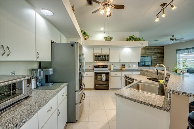 kitchen with visible vents, light tile patterned floors, white cabinets, stainless steel appliances, and a sink