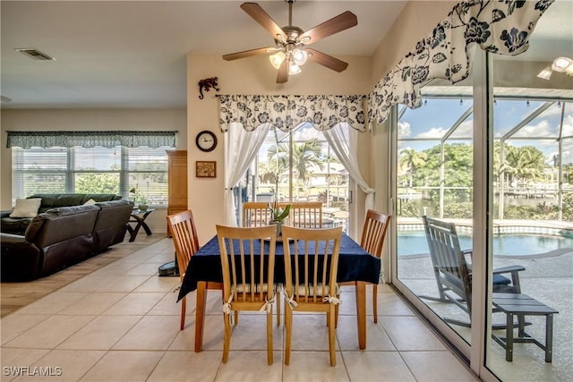 dining space featuring plenty of natural light, visible vents, and light tile patterned flooring