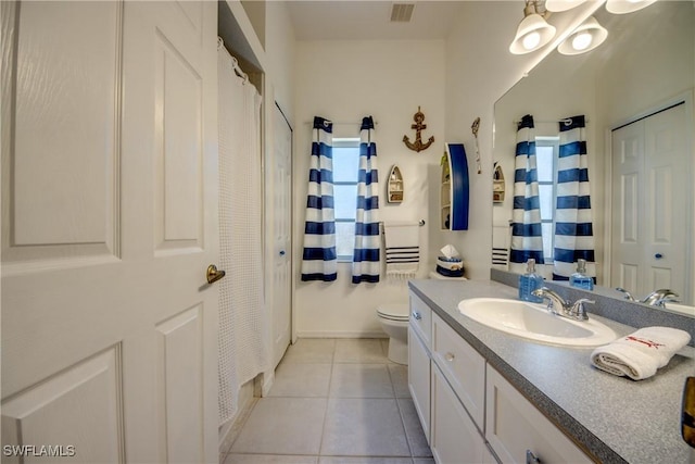 bathroom featuring toilet, a shower with shower curtain, visible vents, vanity, and tile patterned floors