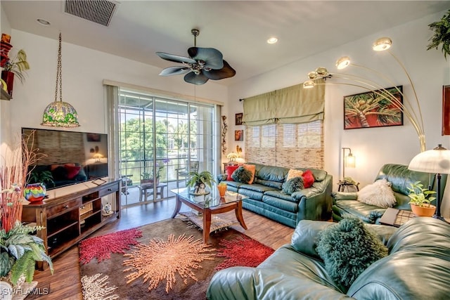 living area with a ceiling fan, recessed lighting, visible vents, and wood finished floors