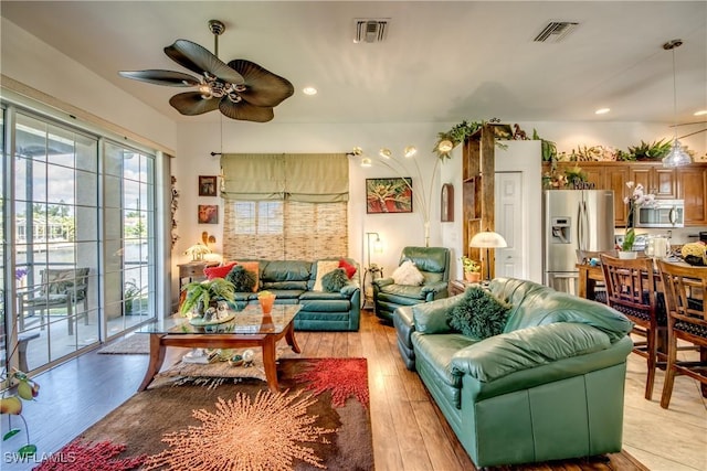 living area with light wood finished floors, visible vents, a ceiling fan, and recessed lighting