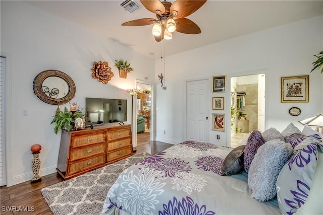 bedroom featuring visible vents, connected bathroom, ceiling fan, baseboards, and wood finished floors