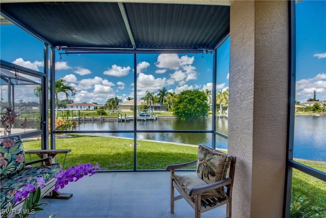 sunroom / solarium featuring a water view