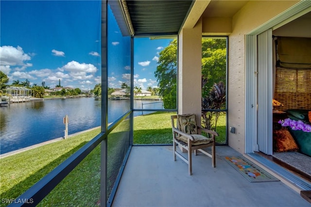 sunroom / solarium featuring a water view and a wealth of natural light