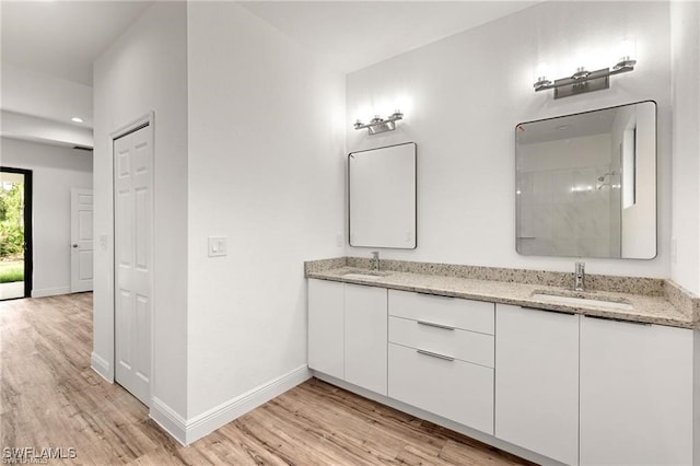 bathroom featuring vanity, hardwood / wood-style floors, and a shower