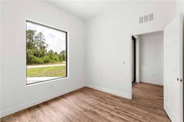 spare room with light hardwood / wood-style flooring