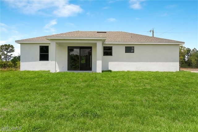 rear view of house with a yard