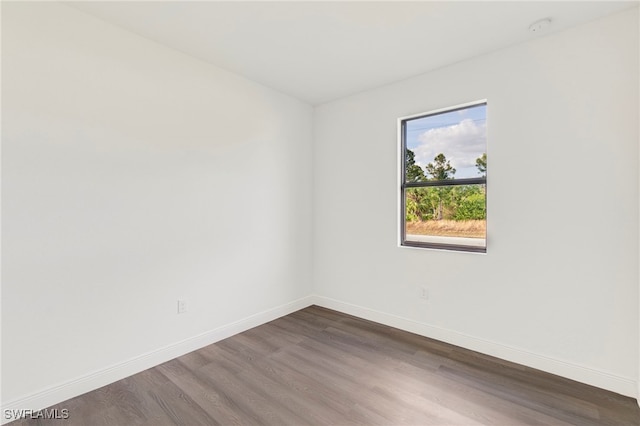 spare room with dark hardwood / wood-style floors