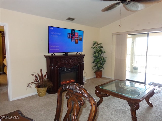 living room with vaulted ceiling, carpet flooring, and ceiling fan