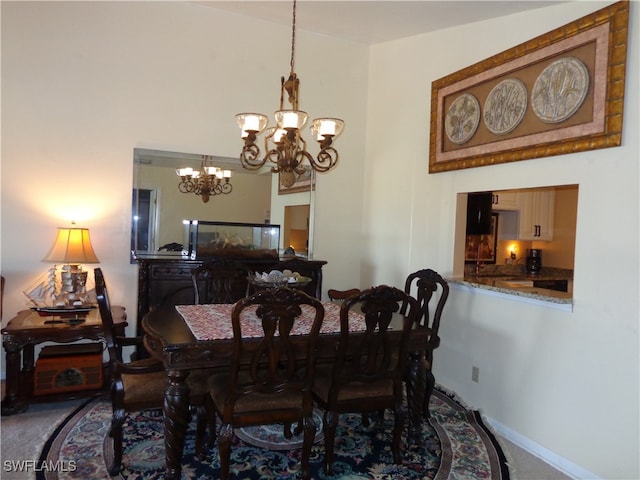 dining space featuring carpet floors and an inviting chandelier