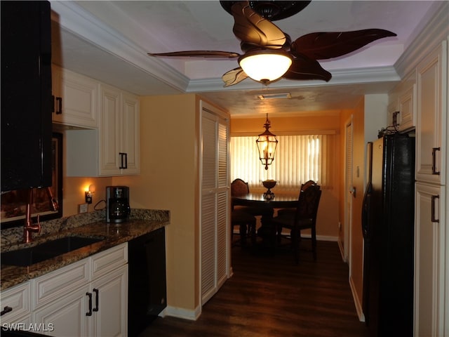 kitchen featuring dark wood-type flooring, ornamental molding, black appliances, pendant lighting, and white cabinets