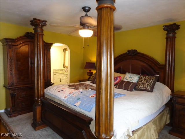 carpeted bedroom featuring connected bathroom and ceiling fan