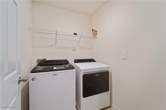 clothes washing area featuring independent washer and dryer