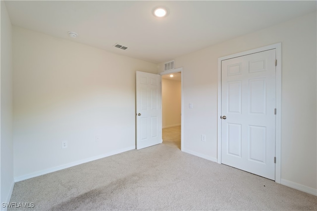 unfurnished bedroom with light carpet