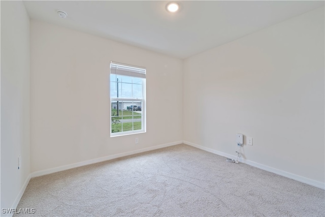 unfurnished room with light carpet