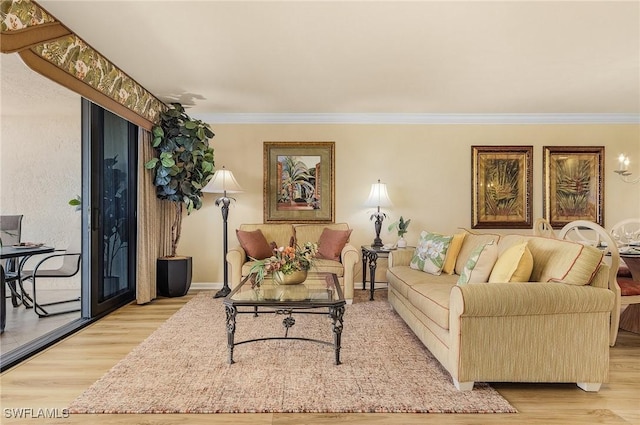 living room featuring light wood-type flooring and ornamental molding