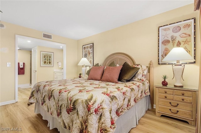 bedroom featuring light hardwood / wood-style floors and ensuite bathroom