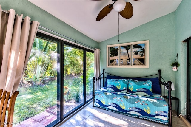 bedroom with vaulted ceiling, a ceiling fan, and a textured wall