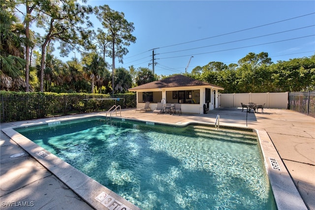 community pool featuring a patio, a storage structure, an outdoor structure, and fence