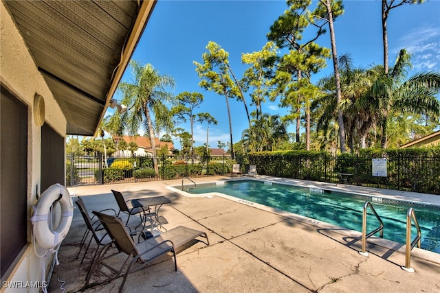 pool with fence and a patio