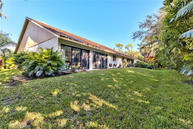 rear view of house with a yard