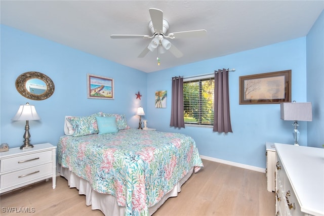 bedroom with light wood finished floors, ceiling fan, and baseboards