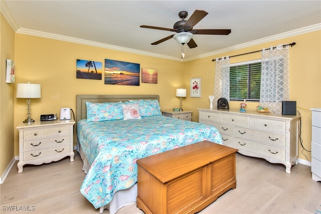 bedroom with light wood finished floors, ornamental molding, a ceiling fan, and baseboards