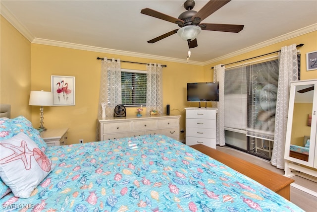 bedroom with ceiling fan, wood finished floors, and crown molding