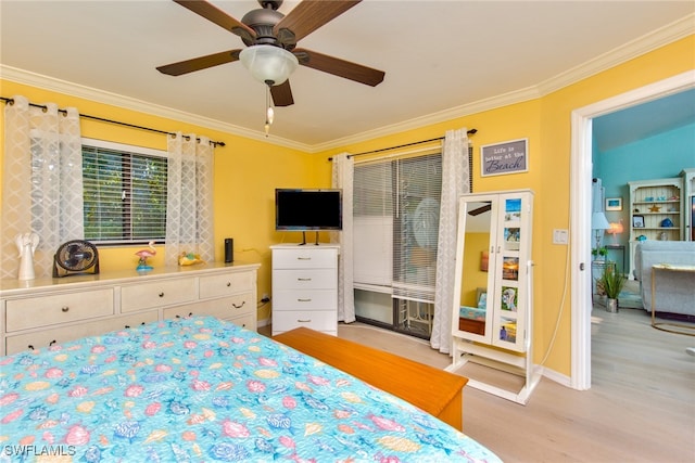 bedroom with ornamental molding, wood finished floors, and a ceiling fan