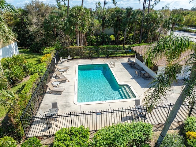 community pool featuring a patio area and fence