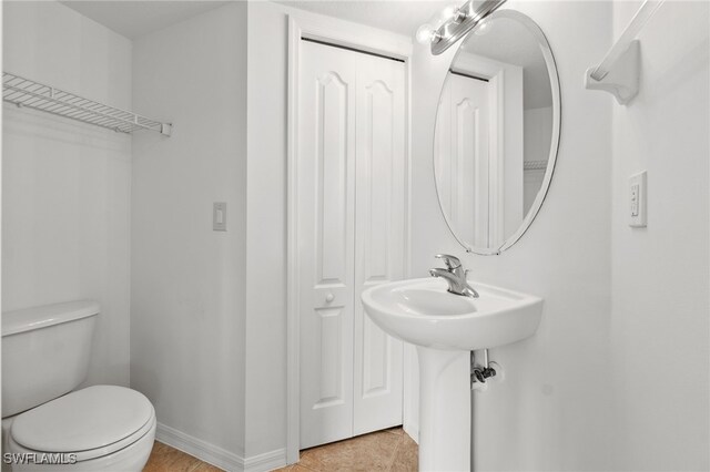 bathroom with tile patterned floors and toilet