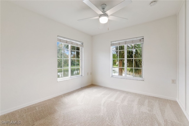 unfurnished room featuring light carpet and ceiling fan