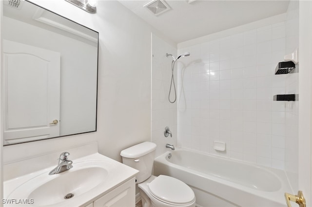 full bathroom featuring vanity, tiled shower / bath combo, and toilet